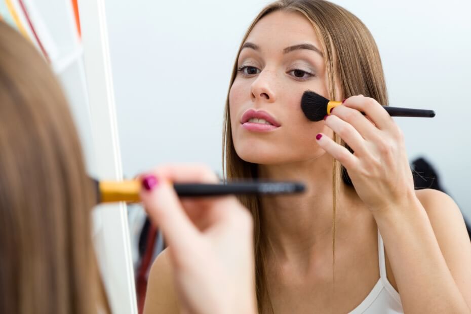 Mujer retocando discretamente su maquillaje como tip de Foriu